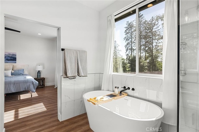 5755 Fickett Ln, Paradise, CA 95969 - bathroom with wood finished floors, a soaking tub, tile walls, and ensuite bath