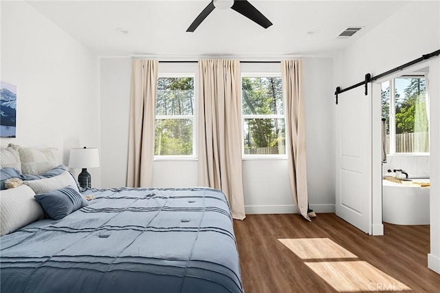 5755 Fickett Ln, Paradise, CA 95969 - bedroom with wood finished floors, a barn door, baseboards, and a ceiling fan
