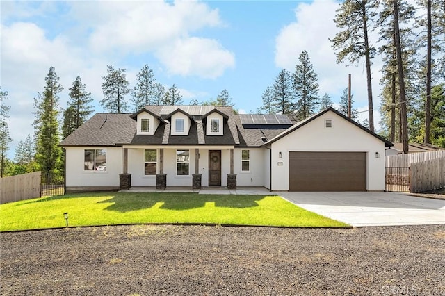 5755 Fickett Ln, Paradise, CA 95969 - modern farmhouse featuring concrete driveway, a garage, roof mounted solar panels, stucco siding, and covered porch