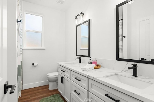 5755 Fickett Ln, Paradise, CA 95969 - full bathroom featuring baseboards, plenty of natural light, wood finished floors, and toilet