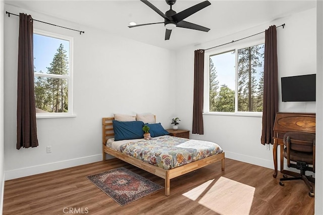 5755 Fickett Ln, Paradise, CA 95969 - bedroom featuring multiple windows, baseboards, and wood finished floors