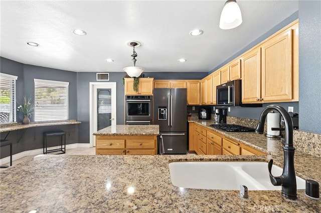 25 Del Brienza, Lake Elsinore, CA 92532 - kitchen featuring stainless steel appliances, light brown cabinetry, light stone countertops, recessed lighting, and hanging light fixtures