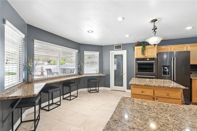 25 Del Brienza, Lake Elsinore, CA 92532 - kitchen featuring high end refrigerator, light stone countertops, recessed lighting, light brown cabinets, and double oven
