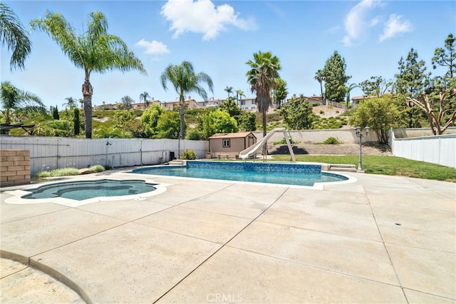 25 Del Brienza, Lake Elsinore, CA 92532 - view of pool with a fenced backyard, a water slide, a patio, and a shed