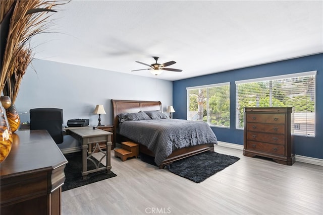 25 Del Brienza, Lake Elsinore, CA 92532 - bedroom featuring light wood-style floors, an office area, and a ceiling fan