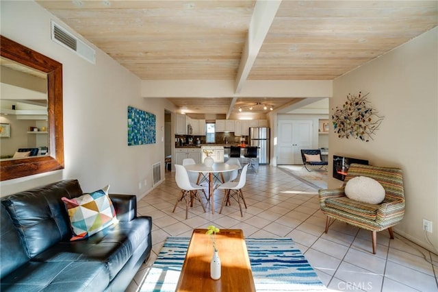 576 E Desert Holly Cir, Palm Springs, CA 92262 - living area with light tile patterned floors, wood ceiling with exposed beams, and baseboards