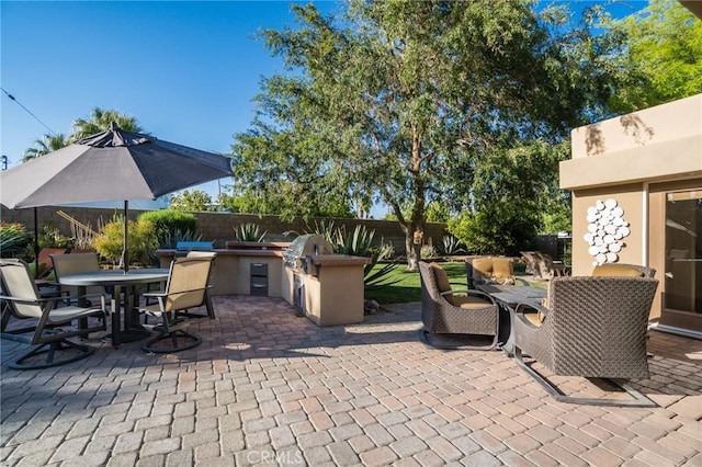 576 E Desert Holly Cir, Palm Springs, CA 92262 - fenced backyard featuring exterior kitchen, outdoor dining area, and a patio