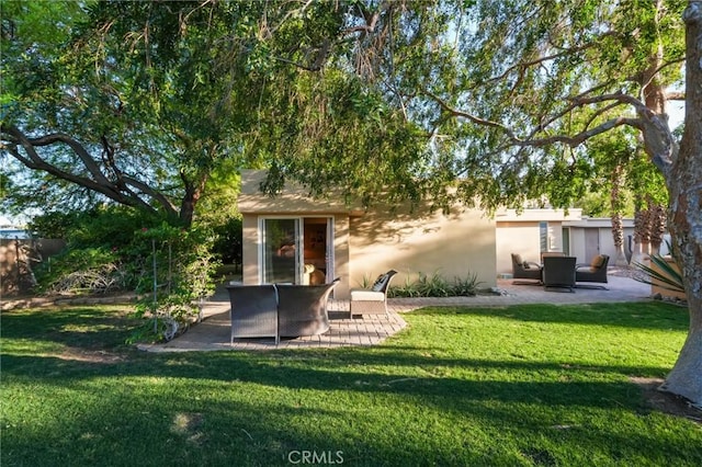 576 E Desert Holly Cir, Palm Springs, CA 92262 - rear view of property with a patio area, a yard, and stucco siding