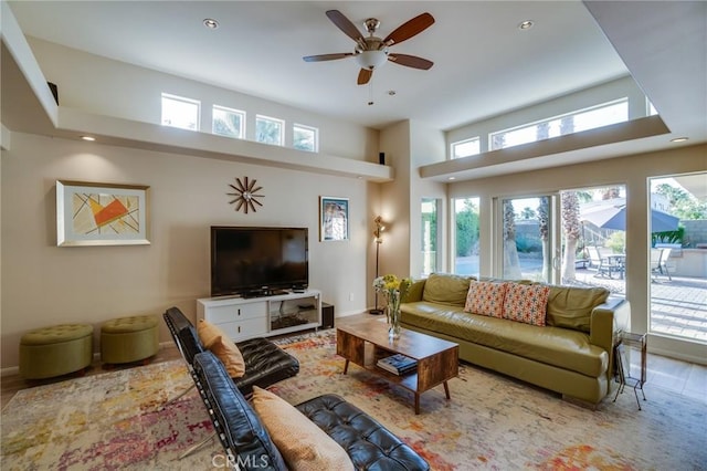 576 E Desert Holly Cir, Palm Springs, CA 92262 - living room with a ceiling fan, recessed lighting, wood finished floors, a towering ceiling, and baseboards
