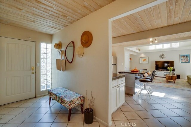 576 E Desert Holly Cir, Palm Springs, CA 92262 - entryway with light tile patterned flooring and wood ceiling with exposed beams
