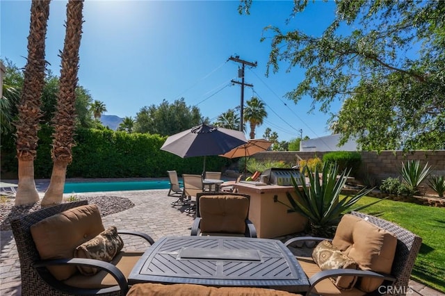 576 E Desert Holly Cir, Palm Springs, CA 92262 - fenced backyard with a patio and outdoor dining space