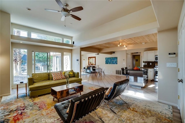 576 E Desert Holly Cir, Palm Springs, CA 92262 - living area with a ceiling fan, beam ceiling, baseboards, and light tile patterned floors