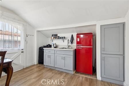 426 Ivy St, Glendale, CA 91204 - kitchen featuring range with gas stovetop, vaulted ceiling, light wood-type flooring, fridge, and a sink