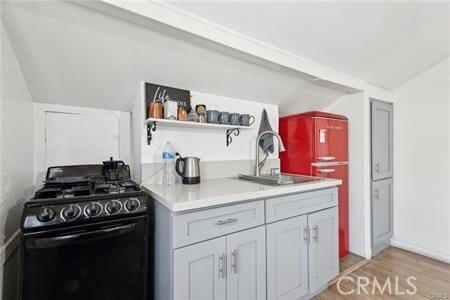 426 Ivy St, Glendale, CA 91204 - kitchen featuring gas stove, vaulted ceiling, a sink, light wood finished floors, and light countertops