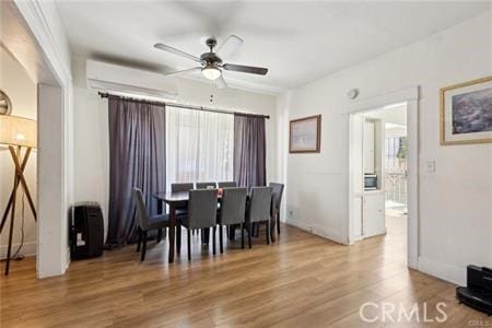 426 Ivy St, Glendale, CA 91204 - dining space with ceiling fan, wood finished floors, a wall unit AC, and baseboards