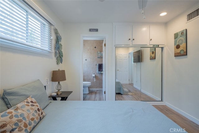 16732 Lassen St, Northridge, CA 91343 - bedroom with light wood-style flooring, connected bathroom, and baseboards