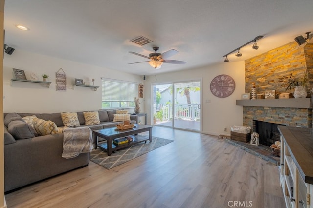 16732 Lassen St, Northridge, CA 91343 - living area with wood finished floors, ceiling fan, a fireplace, and track lighting