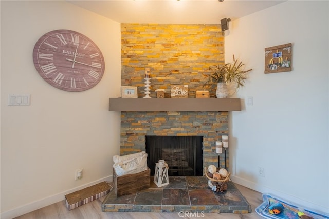 16732 Lassen St, Northridge, CA 91343 - detailed view of wood finished floors, a stone fireplace, and baseboards