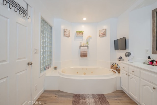 16732 Lassen St, Northridge, CA 91343 - bathroom with a whirlpool tub, wood finished floors, vanity, and recessed lighting