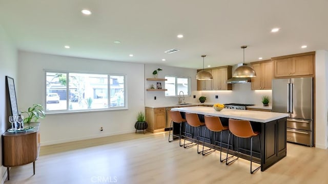 2737 Lorenzo Ave, Costa Mesa, CA 92626 - kitchen featuring high end refrigerator, a sink, wall chimney range hood, open shelves, and light wood-style flooring