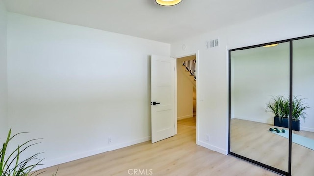 2737 Lorenzo Ave, Costa Mesa, CA 92626 - unfurnished bedroom featuring light wood-style flooring, a closet, and baseboards