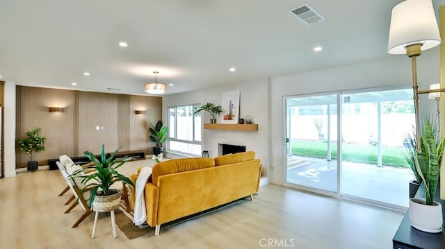 2737 Lorenzo Ave, Costa Mesa, CA 92626 - living area with light wood-type flooring, recessed lighting, and a fireplace
