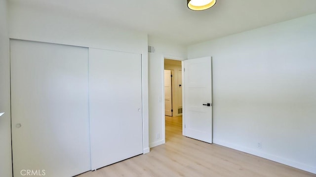 2737 Lorenzo Ave, Costa Mesa, CA 92626 - unfurnished bedroom featuring wood finished floors, a closet, and baseboards