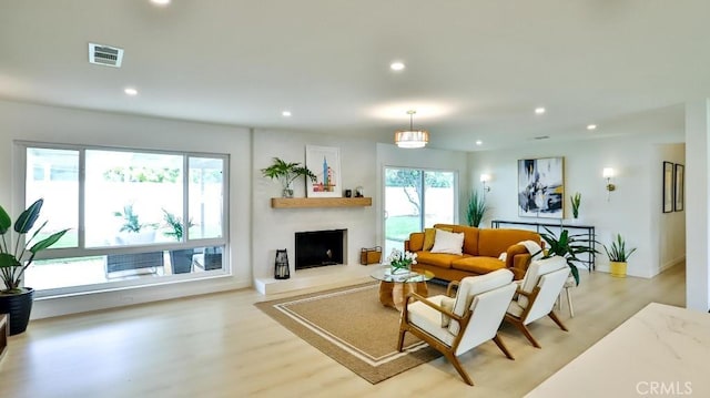 2737 Lorenzo Ave, Costa Mesa, CA 92626 - living room featuring light wood-type flooring, recessed lighting, a large fireplace, and baseboards