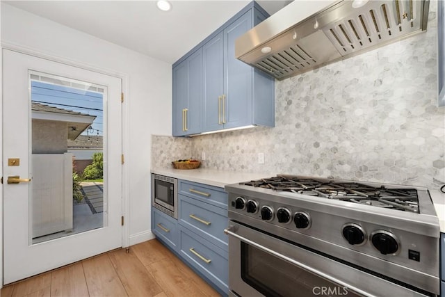 2716 Spreckels, Redondo Beach, CA 90278 - kitchen with stainless steel appliances, blue cabinetry, custom exhaust hood, light wood-style flooring, and light countertops