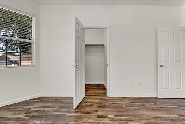 300 S Lombardi St, Porterville, CA 93257 - unfurnished bedroom with wood finished floors, baseboards, a closet, and a spacious closet