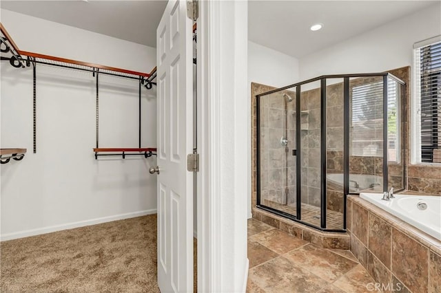300 S Lombardi St, Porterville, CA 93257 - full bathroom featuring a stall shower, a bath, a spacious closet, and baseboards