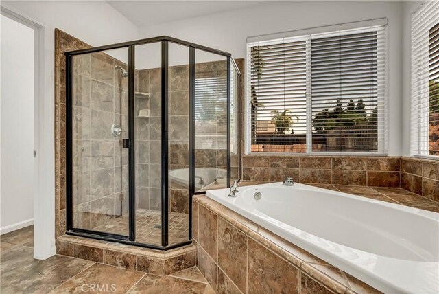 300 S Lombardi St, Porterville, CA 93257 - full bath with a garden tub, a shower stall, and baseboards