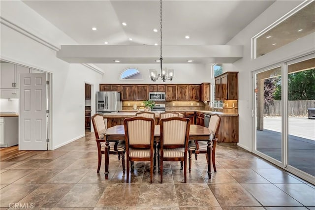 300 S Lombardi St, Porterville, CA 93257 - dining space with a chandelier, recessed lighting, a towering ceiling, and baseboards