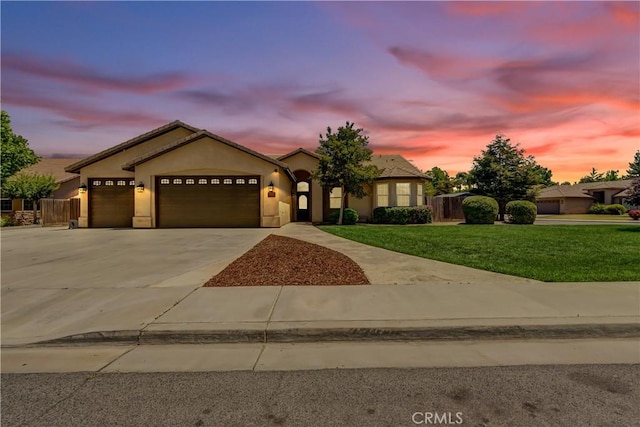 300 S Lombardi St, Porterville, CA 93257 - single story home featuring a garage, concrete driveway, a lawn, and stucco siding