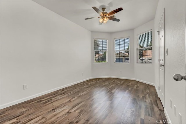 300 S Lombardi St, Porterville, CA 93257 - spare room with dark wood finished floors, ceiling fan, and baseboards