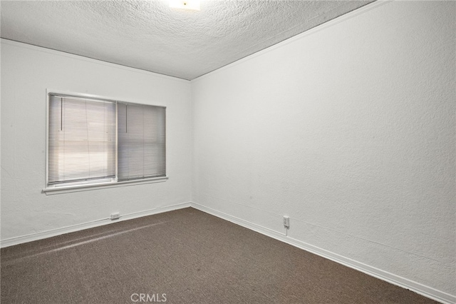 4251 E 4th St, Long Beach, CA 90814 - spare room featuring a textured ceiling, dark colored carpet, and baseboards