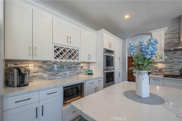429 Tudor Way, Salinas, CA 93906 - kitchen featuring stainless steel double oven, backsplash, white cabinetry, recessed lighting, and light stone counters