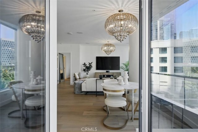 888 W E St Unit 505, San Diego, CA 92101 - dining room featuring a chandelier and wood finished floors