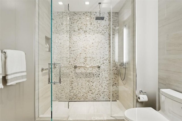 888 W E St Unit 505, San Diego, CA 92101 - bathroom with toilet, a stall shower, and tile walls