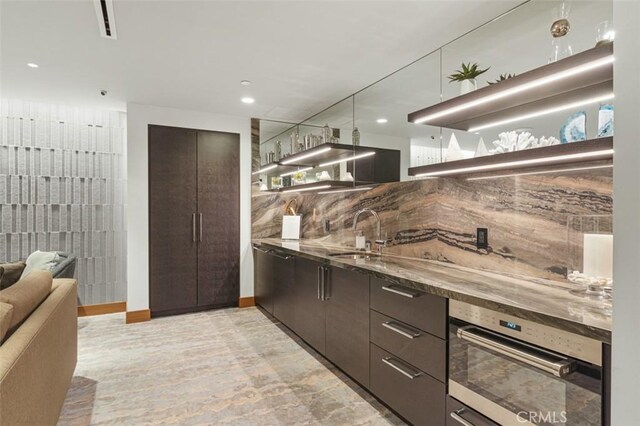 888 W E St Unit 505, San Diego, CA 92101 - kitchen with a sink, oven, modern cabinets, dark brown cabinetry, and recessed lighting