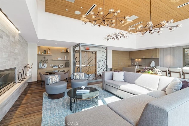 888 W E St Unit 505, San Diego, CA 92101 - living area featuring a chandelier, dark wood-style flooring, a tile fireplace, wood ceiling, and a high ceiling