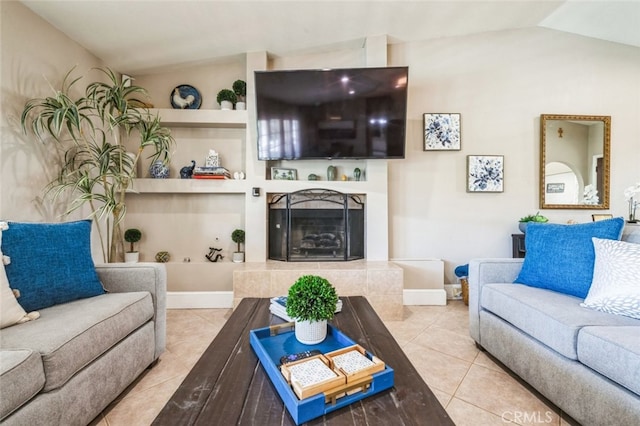 43300 Warner Trl, Palm Desert, CA 92211 - living area with tile patterned flooring, a tile fireplace, lofted ceiling, baseboards, and built in shelves