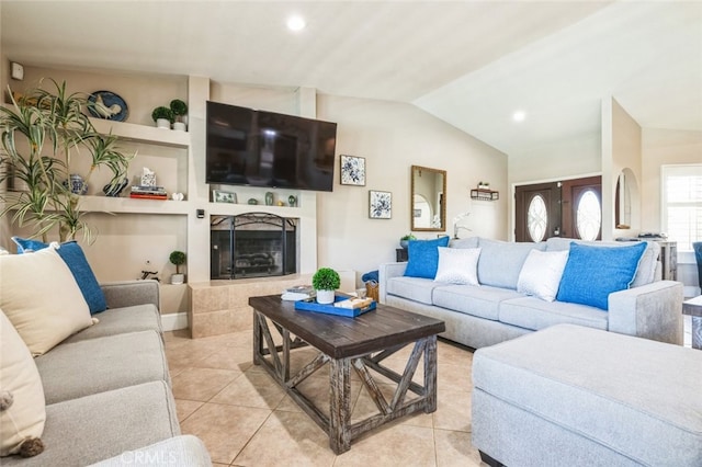 43300 Warner Trl, Palm Desert, CA 92211 - living area featuring light tile patterned floors, built in shelves, vaulted ceiling, a fireplace with raised hearth, and recessed lighting