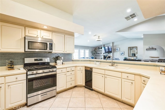 43300 Warner Trl, Palm Desert, CA 92211 - kitchen with stainless steel appliances, a sink, light countertops, decorative backsplash, and recessed lighting