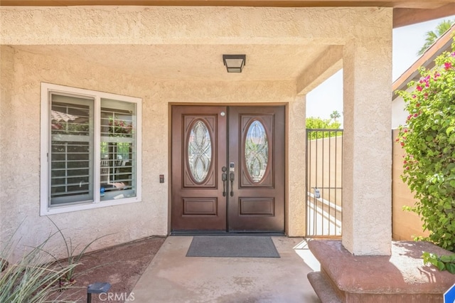 43300 Warner Trl, Palm Desert, CA 92211 - view of exterior entry featuring stucco siding and french doors