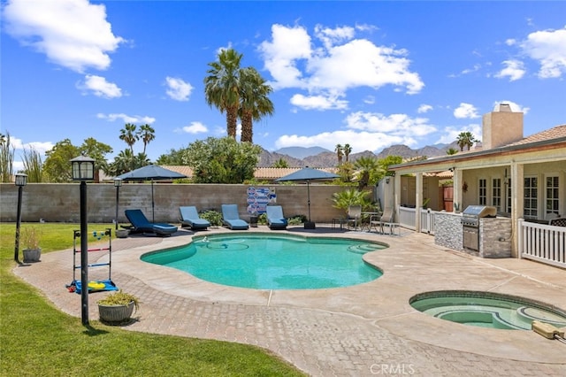 43300 Warner Trl, Palm Desert, CA 92211 - view of pool with an in-ground hot tub, a patio area, a fenced backyard, and a mountain view