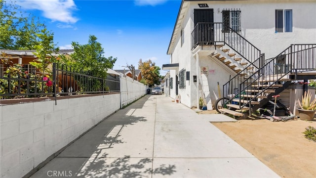 413 E 81st St, Los Angeles, CA 90003 - view of side of home with stairway and stucco siding