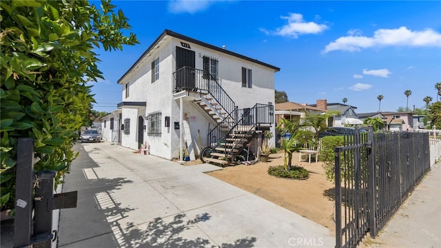 413 E 81st St, Los Angeles, CA 90003 - view of front of property featuring stairs, stucco siding, and a residential view