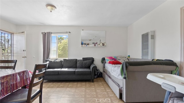 413 E 81st St, Los Angeles, CA 90003 - living room with a heating unit, plenty of natural light, and light flooring