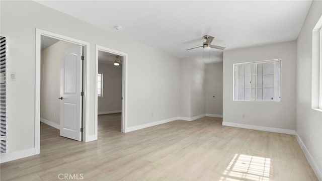 413 E 81st St, Los Angeles, CA 90003 - empty room with ceiling fan, plenty of natural light, light wood-type flooring, and baseboards